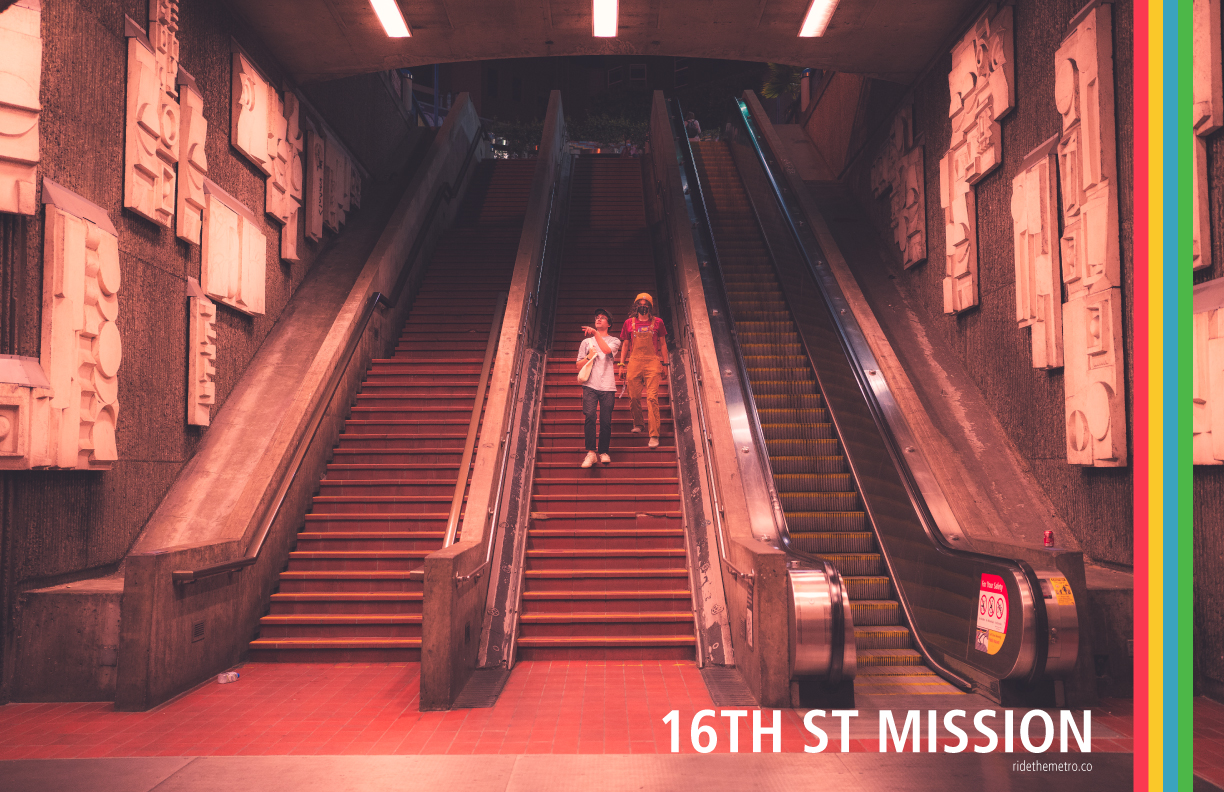 A photo poster design that says 16th St Mission, with red yellow blue and green vertical lines overlaid on the right. The photo shows brown tile staircases and an escalator to the surface, in a wide open space between textured concrete walls, which have tan artistic paneling partially covering them. There are two people walking down the central staircase together. One person is wearing jeans and a light T-shirt, and is pointing at something out of the photo. The second person is wearing brown overalls with a red t-shirt, and yellow beanie with a face mask.